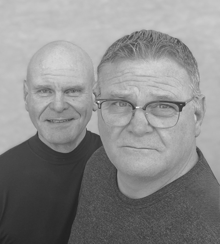 Black and white author photo of identical twins Phil and Paul Garver, the writing duo behind the pen name Daniel P. Douglas.